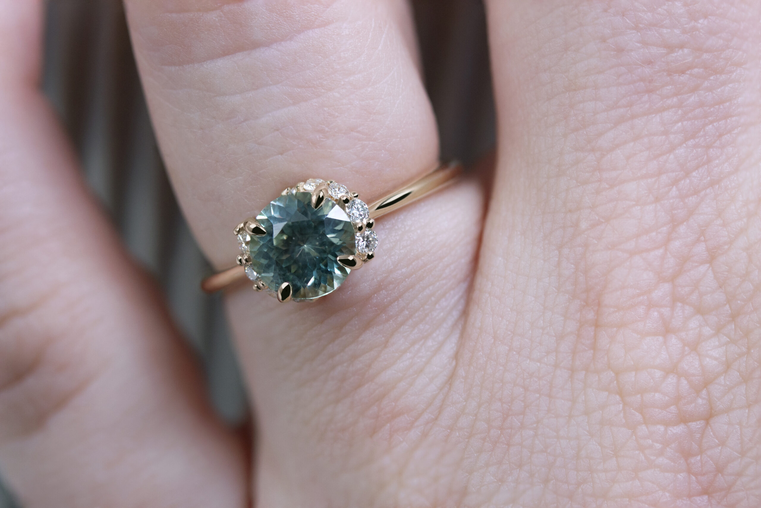 Spiral Staircase Ring by Philadelphia local jeweler Emily Chelsea Jewelry, showcasing reclaimed diamonds, a sparkling center stone, and a unique 2mm band design.